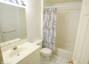 Thumbnail 8 of 14 - a bathroom with a toilet and a sink and a shower
