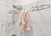 Thumbnail 11 of 37 - A pink robe is hanging on a clothesline with other clothes.