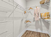Thumbnail 8 of 37 - A walk-in closet with a pink robe hanging on a hanger.
