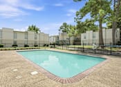 Thumbnail 4 of 37 - A small pool in a courtyard surrounded by buildings.
