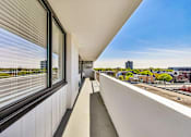 Thumbnail 35 of 54 - A balcony with a view of a cityscape.
