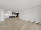 Thumbnail 34 of 54 - A room with wooden flooring and white walls.