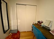 Thumbnail 15 of 25 - A room with a desk and chair in front of a white wall.