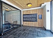 Thumbnail 6 of 9 - A room with a wooden ceiling and a glass door leading to a balcony.