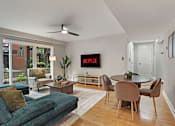 Thumbnail 28 of 31 - A living room with a TV displaying the Netflix logo.