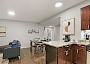 Thumbnail 13 of 15 - a living room with a kitchen and a dining room