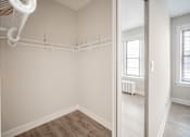 Thumbnail 23 of 24 - A white closet with a white shelf and a white fan.