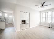 Thumbnail 18 of 24 - A spacious living room with a fireplace and sliding glass doors.