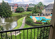 Thumbnail 21 of 23 - A view of a pool and fountain from a balcony.