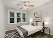 Thumbnail 15 of 15 - a bedroom with a bed and a ceiling fan