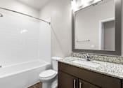 Thumbnail 22 of 37 - A white bathroom with a toilet, sink, and bathtub.
