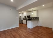 Thumbnail 2 of 13 - A kitchen area with a white countertop and a white fridge.