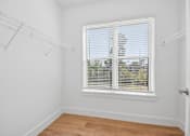 Thumbnail 43 of 60 - A room with a window and a wooden floor.