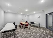 Thumbnail 35 of 60 - A conference room with a white table and chairs.
