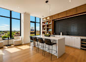 Thumbnail 12 of 18 - A modern kitchen with a dining table and chairs.