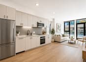 Thumbnail 14 of 18 - A modern kitchen with stainless steel appliances and white cabinetry.