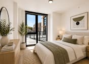 Thumbnail 16 of 18 - A bedroom with a large bed and a view of the city through the window.