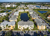 Thumbnail 10 of 37 - A large apartment complex with a lake in the middle.