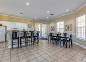 Thumbnail 9 of 37 - A kitchen with a dining table and chairs.