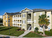 Thumbnail 1 of 37 - A building with a palm tree in front of it.