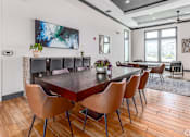 Thumbnail 8 of 35 - A modern dining room with a large table and chairs.