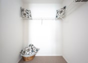 Thumbnail 11 of 24 - A room with a white wall and a basket on the floor.