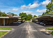 Thumbnail 24 of 24 - A parking lot with cars parked in it.