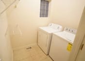 Thumbnail 11 of 14 - a laundry room with a washer and dryer in it
