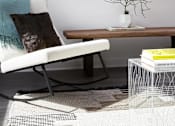 Thumbnail 12 of 31 - A white chair with a blue pillow is in front of a window.