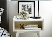 Thumbnail 13 of 31 - A black and white photo is framed and placed on a small white desk with a black lamp.