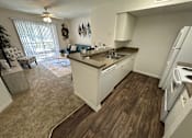 Thumbnail 29 of 48 - A kitchen with white cabinets and a wooden floor.