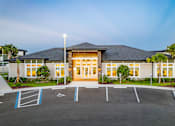 Thumbnail 2 of 46 - A building with a parking lot in front of it.
