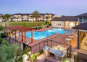 Thumbnail 5 of 46 - A poolside area with a hot tub and loungers.