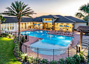 Thumbnail 7 of 46 - A large house with a pool in the backyard.