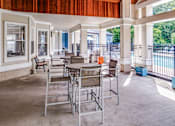Thumbnail 16 of 48 - A patio with a table and chairs is shown.