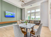 Thumbnail 28 of 46 - A modern dining room with a glass table and chairs.