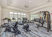 Thumbnail 26 of 46 - A spacious gym with a variety of exercise equipment.
