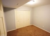 Thumbnail 13 of 14 - a room with a carpeted floor and two closets