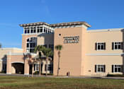 Thumbnail 9 of 44 - A library building with a sign on the front.