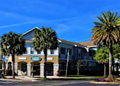 Thumbnail 26 of 44 - A building with a sign that says "Living Center" is surrounded by palm trees.