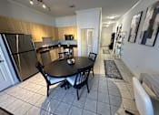 Thumbnail 9 of 29 - A kitchen with a table and chairs.