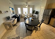 Thumbnail 8 of 29 - A kitchen with a table and chairs in the middle of the room.