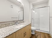 Thumbnail 16 of 50 - A bathroom with a sink, toilet, and shower.