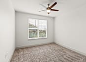 Thumbnail 17 of 50 - A room with a ceiling fan and a window with blinds.