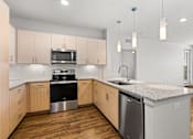Thumbnail 8 of 50 - A kitchen with wooden cabinets and granite countertops.