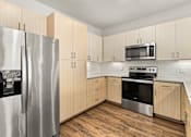 Thumbnail 10 of 50 - A kitchen with a stainless steel refrigerator and oven.