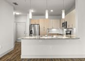 Thumbnail 11 of 50 - A kitchen with a granite countertop and wooden cabinets.