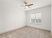 Thumbnail 14 of 50 - A room with a ceiling fan and a window with blinds.