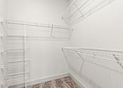 Thumbnail 15 of 50 - Empty white shelves in a room.