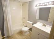 Thumbnail 12 of 14 - a bathroom with a toilet and a sink and a shower
